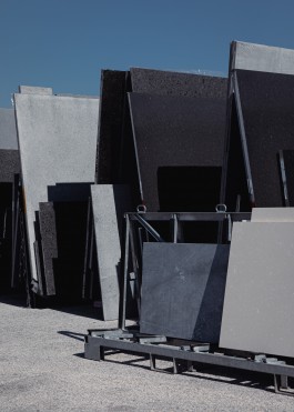granite plates of various sizes stacked up in an outside storage
