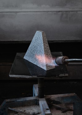 A blow torch is used to dry a granite trapezoid