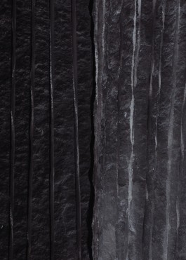 charred black granite rockface